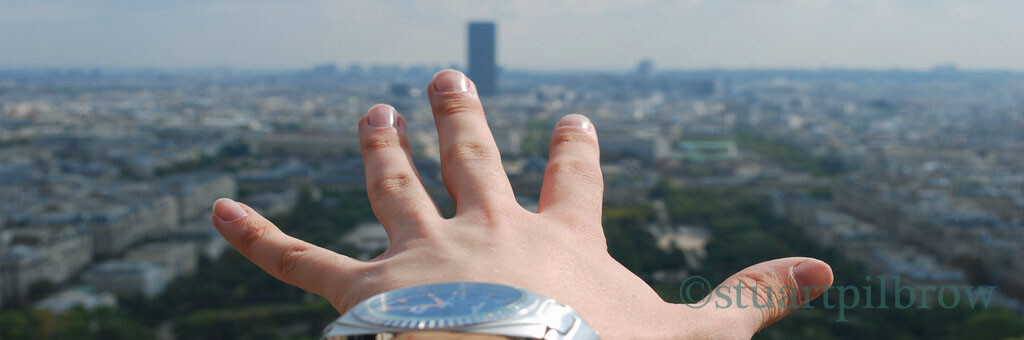 Person's hand pointing to city