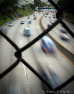Photo of highway through a gate