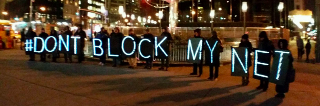people holding sign spelling "#don't block my net"