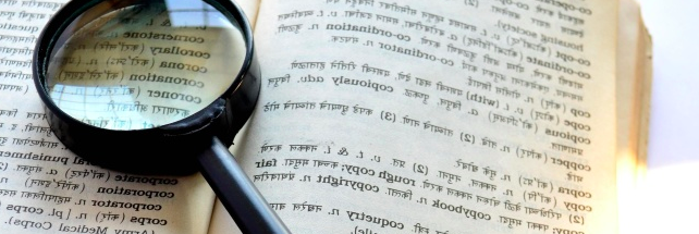 magnifying glass on book in different language