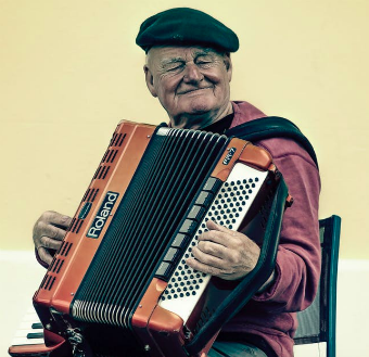 old man playing an accordian
