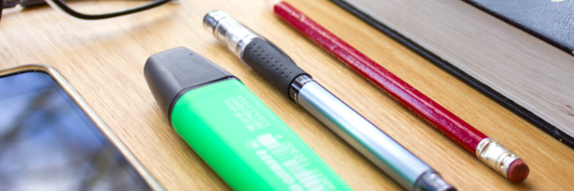Highlighter next to a pen next to a pencil