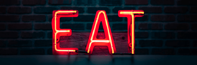 Red neon sign spelling EAT